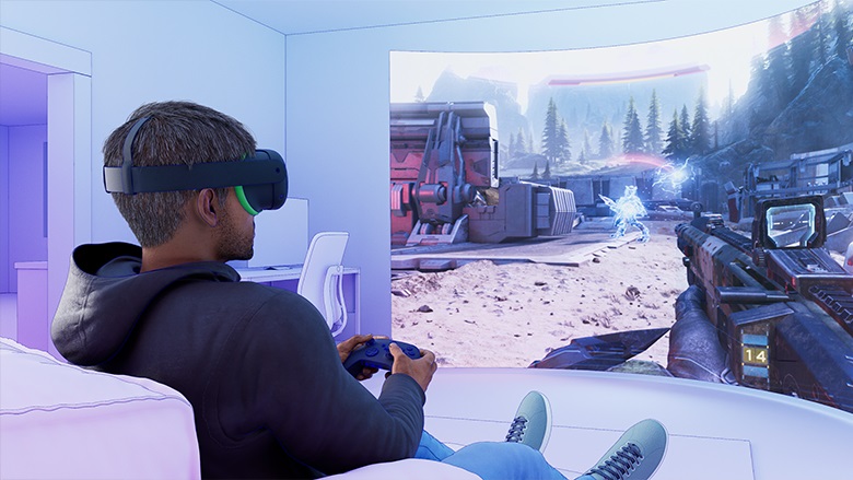 Animated image of man sitting on chair with VR headset playing a game.